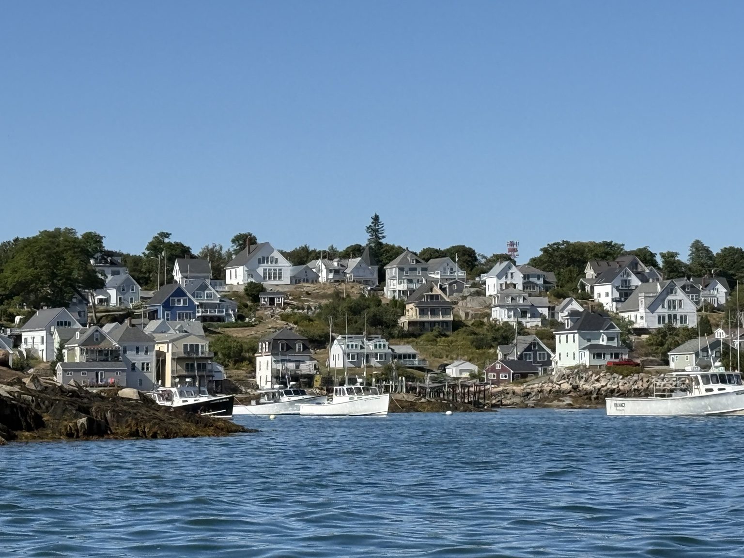 Water view toward hillside homes in Stonington on Deer Isle