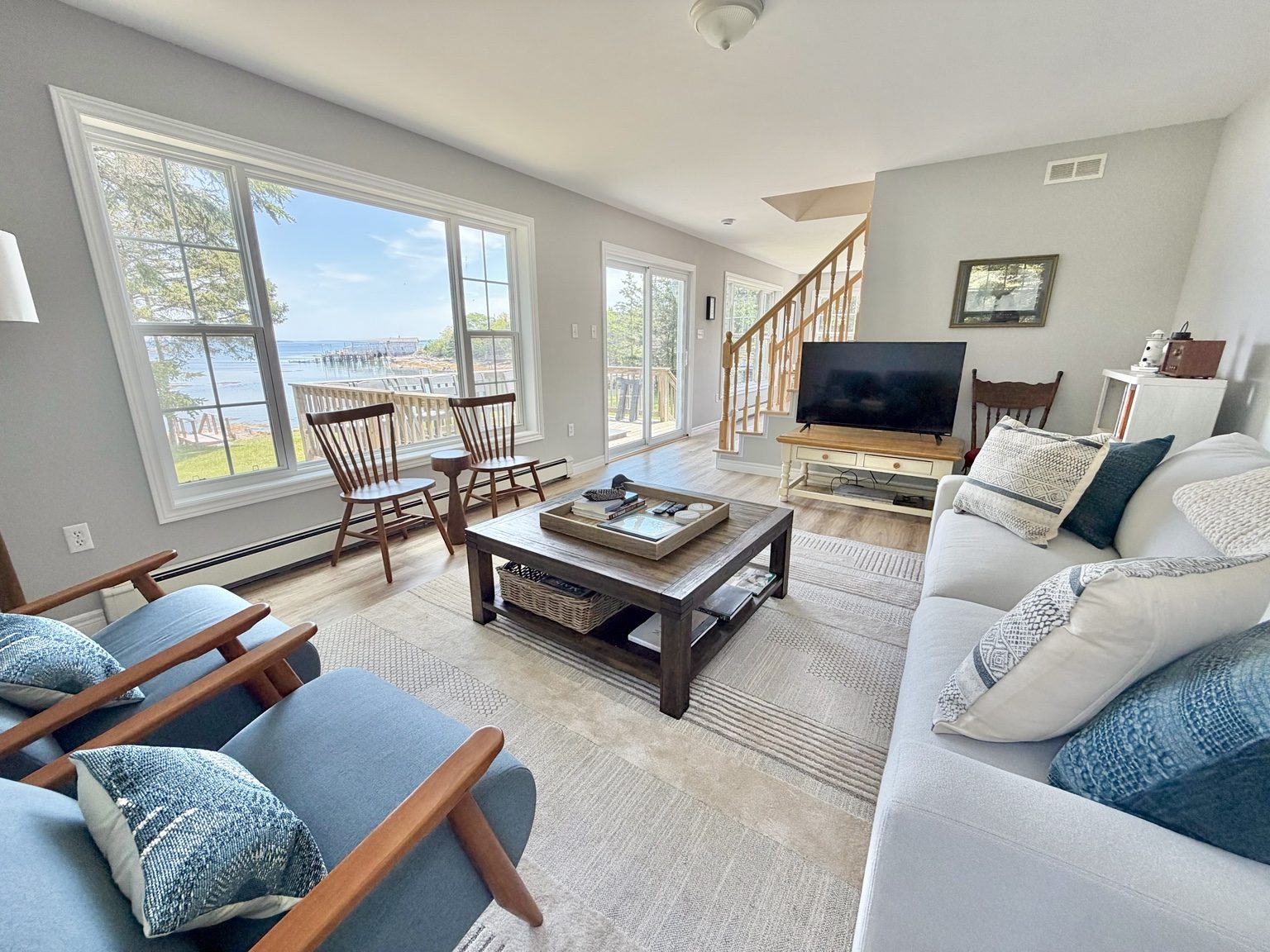 Living room with water view at Ledge & Tide